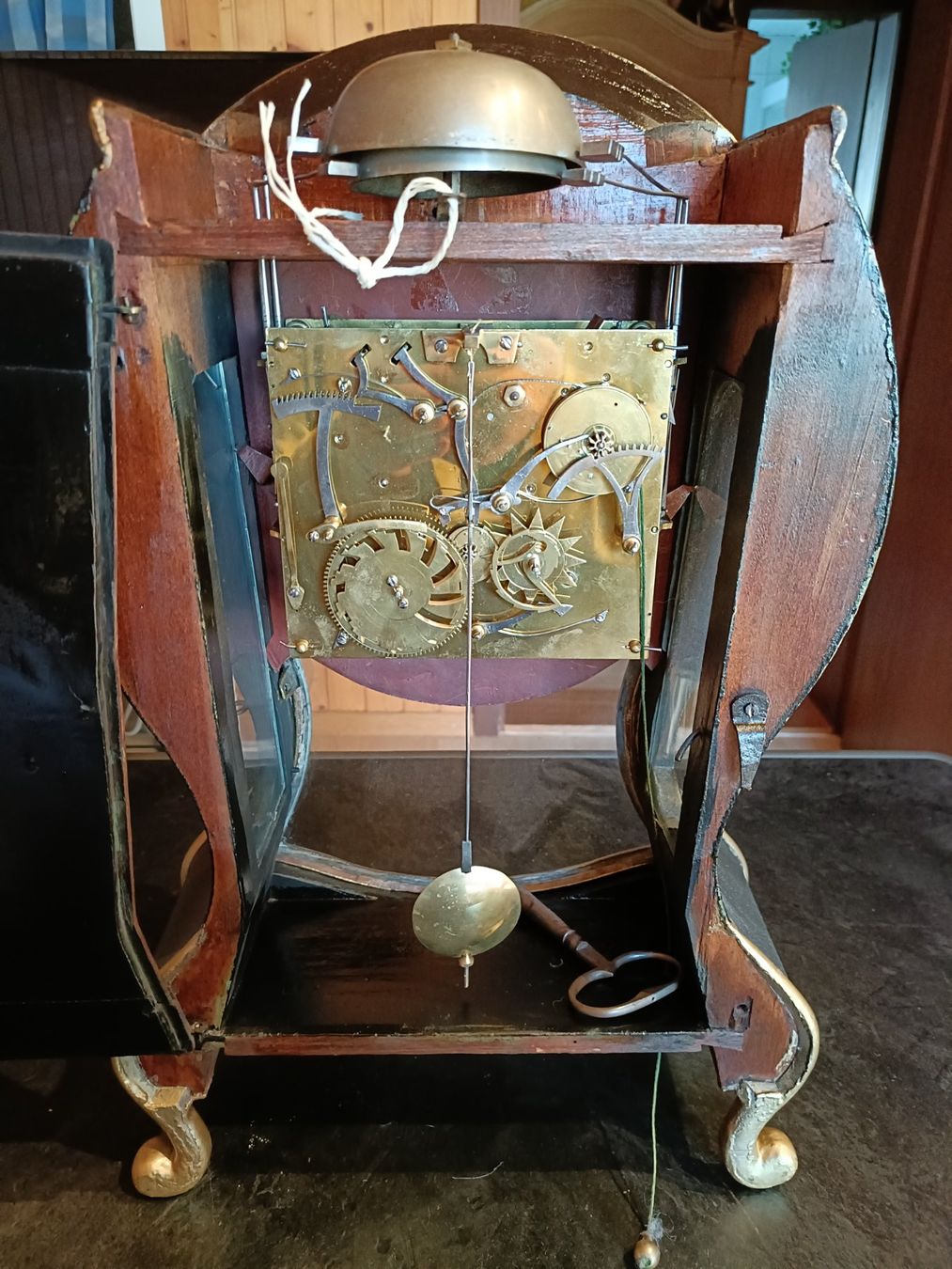 Antique wall clock with black and gold finishes