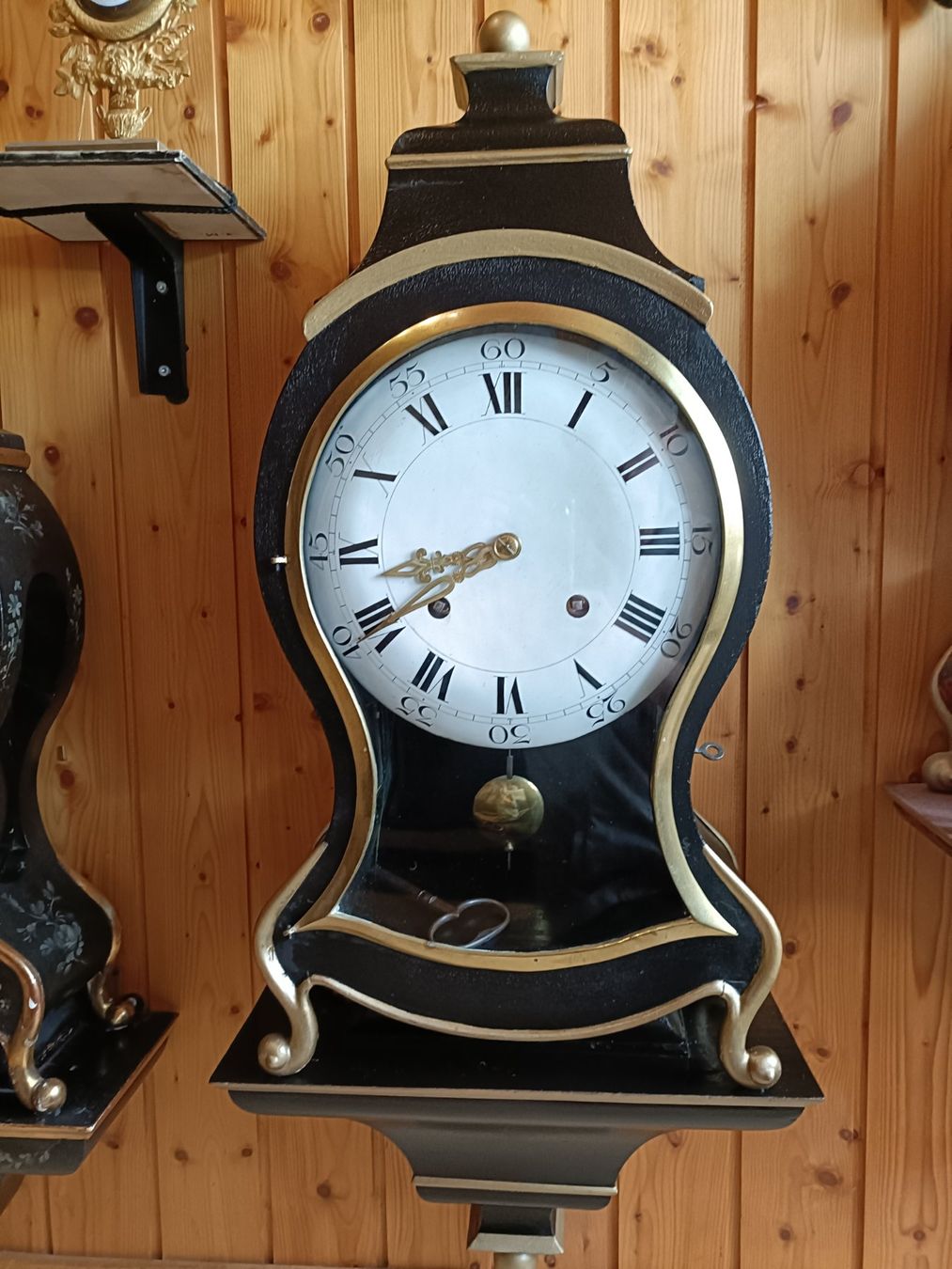 Antique wall clock with black and gold finishes