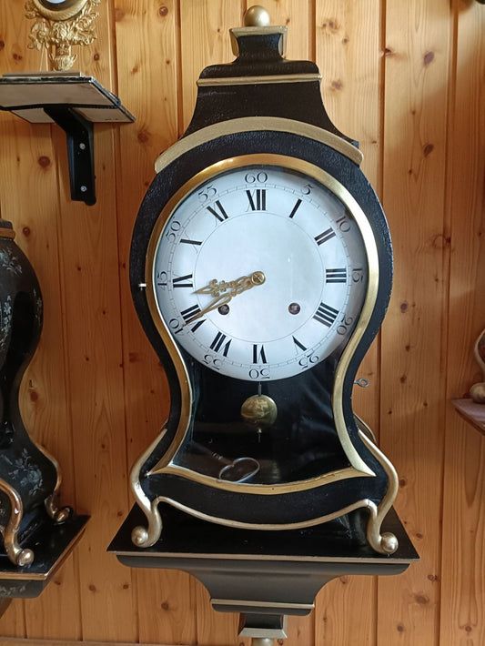 Antique wall clock with black and gold finishes
