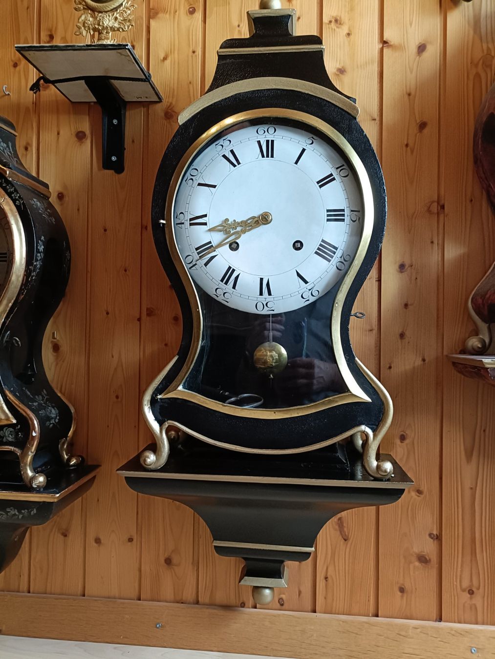 Antique wall clock with black and gold finishes