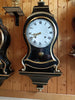 Antique wall clock with black and gold finishes