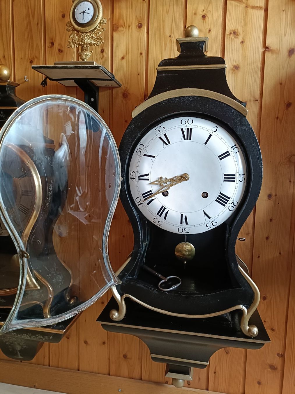 Antique wall clock with black and gold finishes