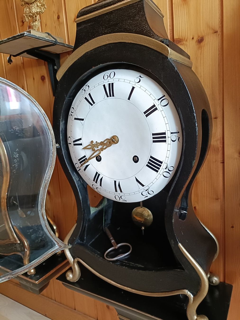 Antique wall clock with black and gold finishes