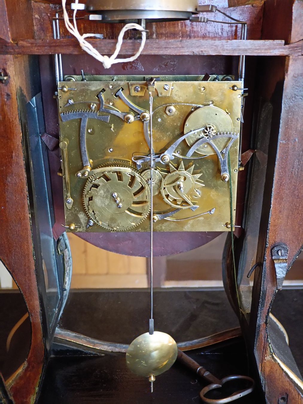 Antique wall clock with black and gold finishes