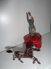 Mechanical circus toy depicting a clown balancing on its hands