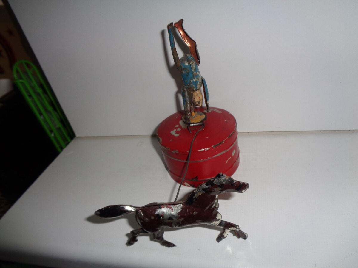Mechanical circus toy depicting a clown balancing on its hands