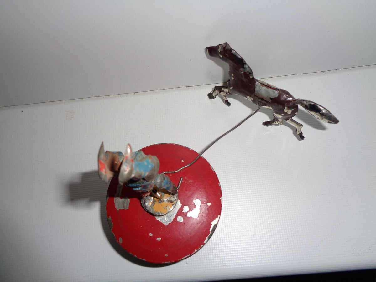 Mechanical circus toy depicting a clown balancing on its hands