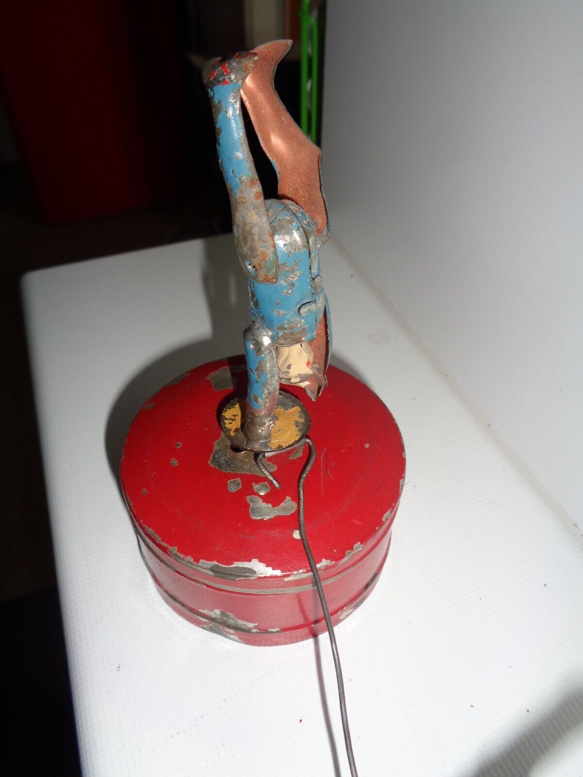 Mechanical circus toy depicting a clown balancing on its hands