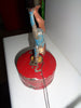 Mechanical circus toy depicting a clown balancing on its hands