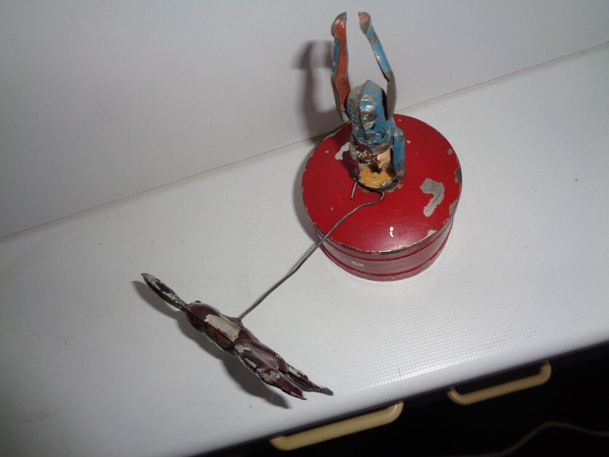Mechanical circus toy depicting a clown balancing on its hands
