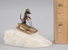 Antique Austrian miniature bronze sculpture depicting a dachshund sledding in the snow.