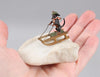 Antique Austrian miniature bronze sculpture depicting a dachshund sledding in the snow.